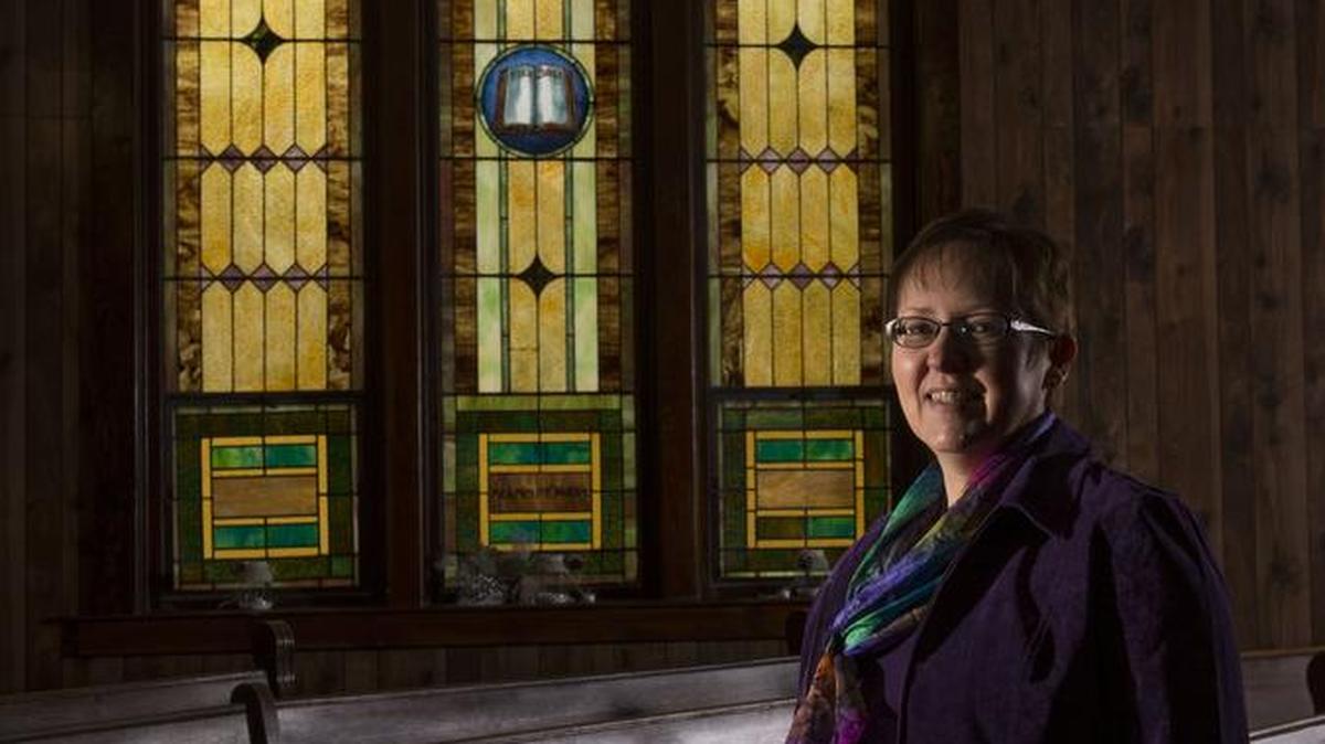 The Rev. Cynthia Meyer stands among the pews at Edgerton United Methodist Church on Jan. 6 in Edgerton, Kan. Meyer recently came out as a lesbian to her congregation.