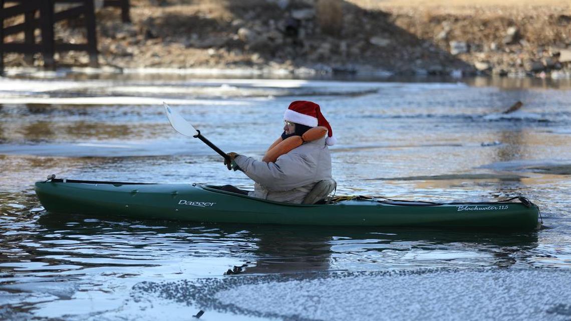 Russ Ike paddles his kayak past a patch of ice on New Year’s Day 2018.  This year, a New Year’s float trip on the Arkansas River will celebrate the 150th anniversary of Wichita’s incorporation as a city.