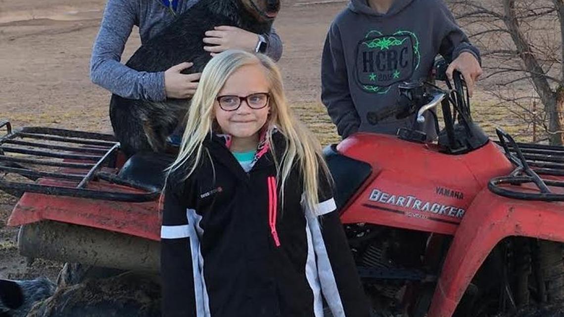 From left, Reese, 14, Kashlee, 6, and Britt, 11, with the family’s blue heeler, Doc. The Grigsby family and their friends used four-wheelers the day of the fire to help herd cattle to safety.