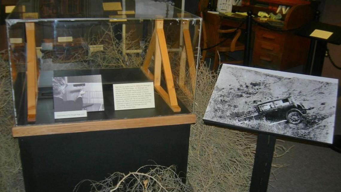 A car window is held upright between two wooden stands at a new exhibit at the Finney County Historical Museum in Garden City. A fingerprint left on the car window by Jake Flaegle of the infamous Fleagle Gang still can be seen on it. The case is surrounded by tumbleweeds similar to how the gang’s stolen car was found in 1928.