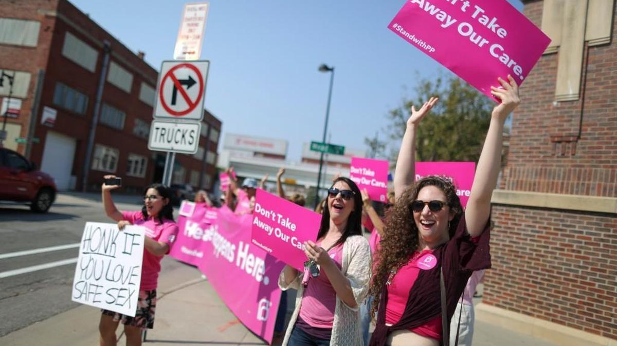 Hannah Meyer, right, and Ashley Parton, second from right, were two of several people to take part in a Planned Parenthood support rally at Old Town Square in September 2015.