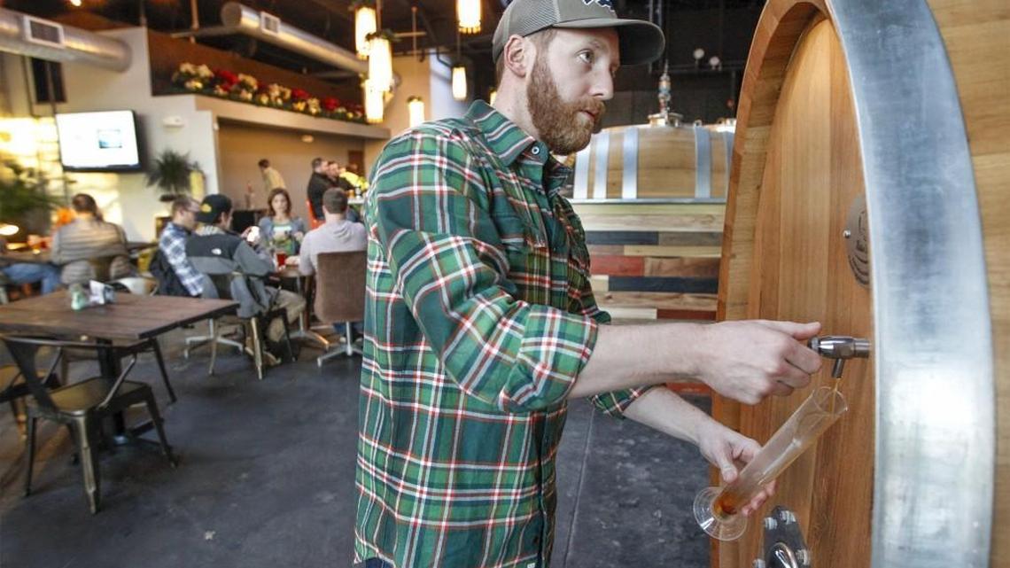Central Standard Brewing owner Ian Crane checks the quality of one of his beers Wednesday.