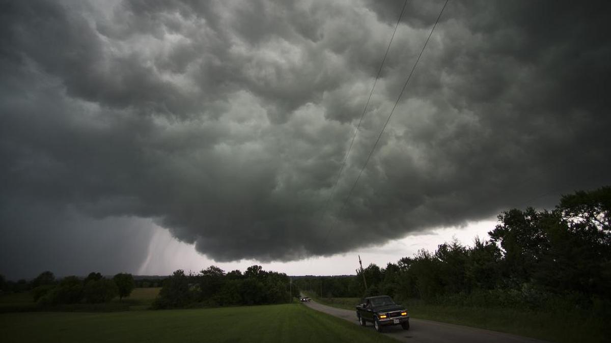 Tornado sirens warned residents as a series of ominous storm clouds passed through the area in Jackson County (left) and Cass County at 155th Street near Raymore in 2015.