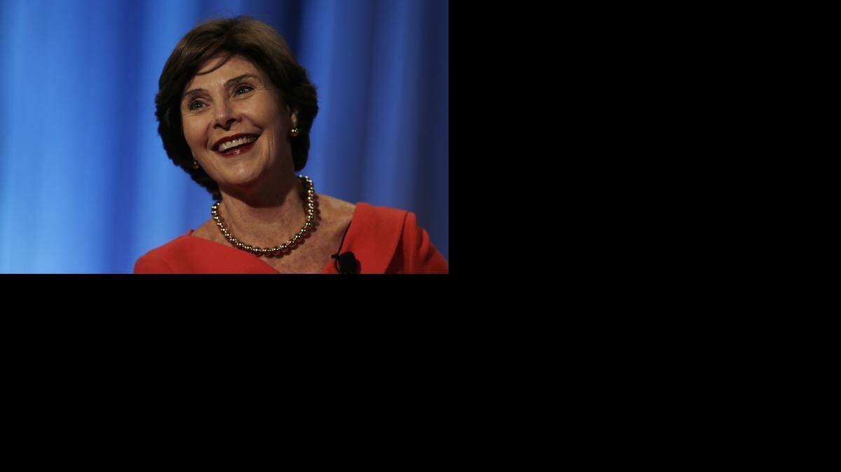 
Former first lady Laura Bush listens as she talks with her daughter Jenna Bush Hager during a fundraising event at Middlesex Community College, in Lowell, Mass., last year. 
