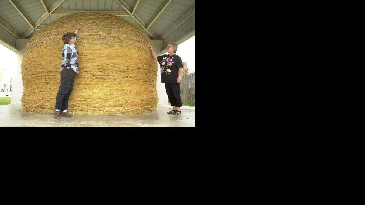 
In 2003, Lottie Herod of Cawker City, left, tried to reach the top of the “World’s Largest Ball of Twine” with Linda Clover, the “keeper of the twine.” Cawker City was celebrating the 50th anniversary of the quirky Kansas attraction.
