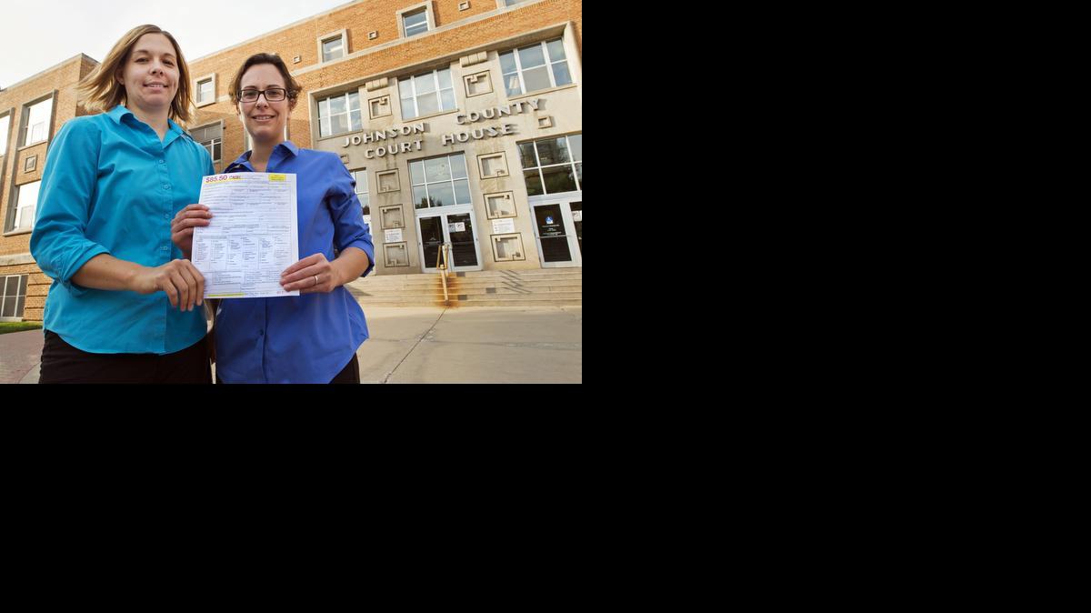 
Angela Schaefer, left, and her partner, Jennifer Schaefer, hold an application for a marriage license at the clerk’s office at the Johnson County Courthouse this week in Olathe. 
