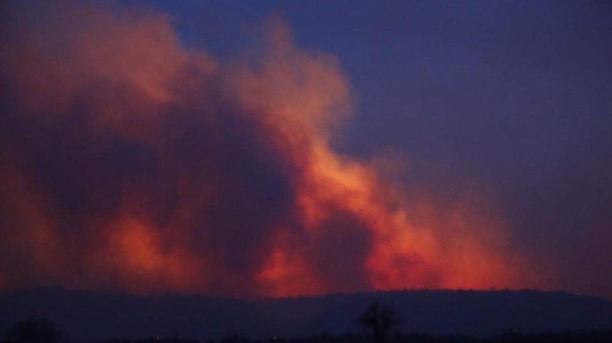 Flames and smoke light up the night sky west of Freedom, Okla., on Tuesday night. A range fire driven by 50 mph winds threatened to cross over into Kansas similar to the Anderson Creek fire two weeks ago. (April 5, 2016)