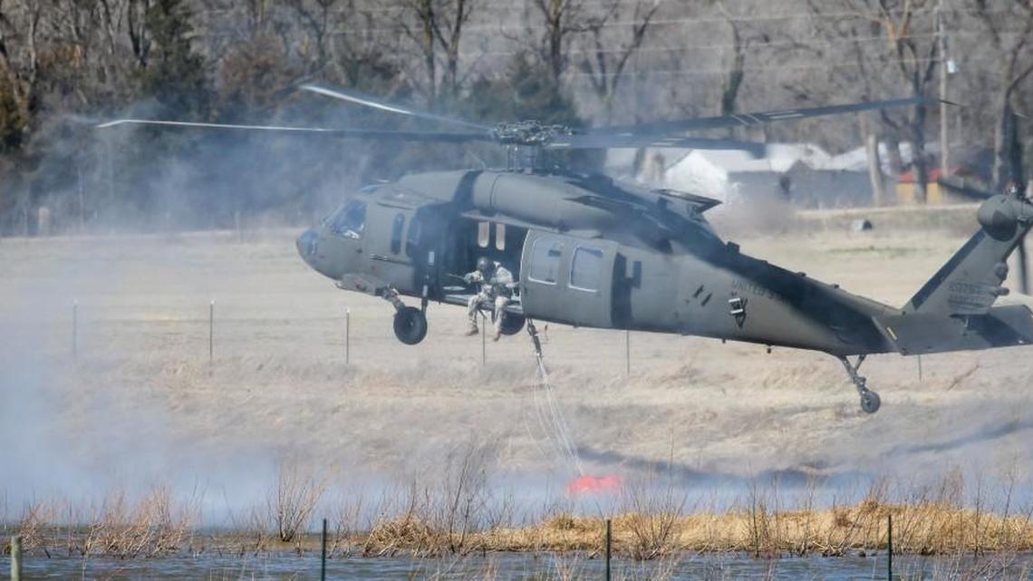 A Blackhawk helicopter uses a bambi bucket to get water from a cattle pond north of Hutchinson on March 7.