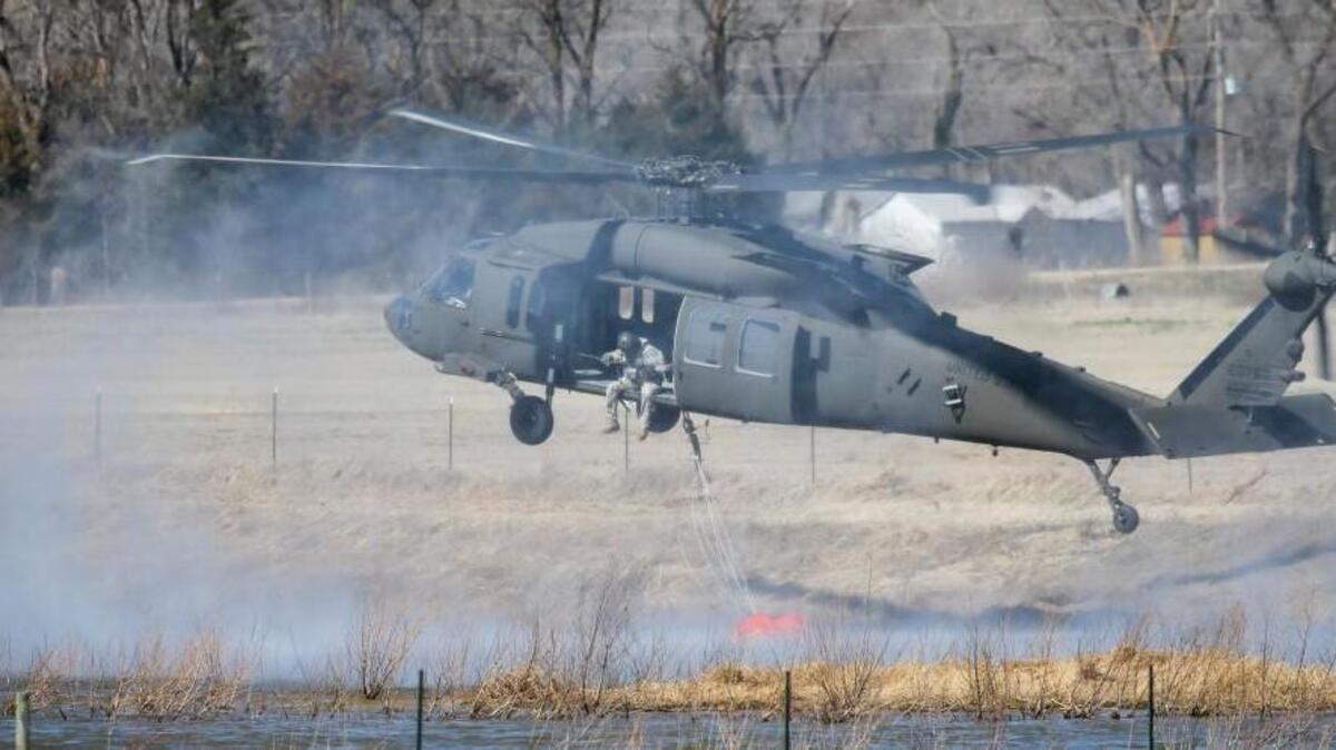 A Blackhawk helicopter uses a bambi bucket to get water from a cattle pond north of Hutchinson on March 7.
