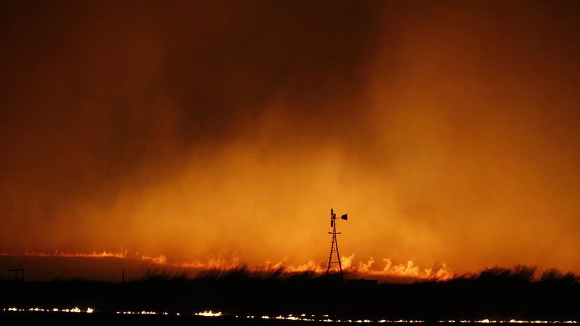 Flames consume the prairie north of Protection as a wildfire, swept by winds of up to 50 mph, burned hundreds of thousands of acres across southern and central Kansas.