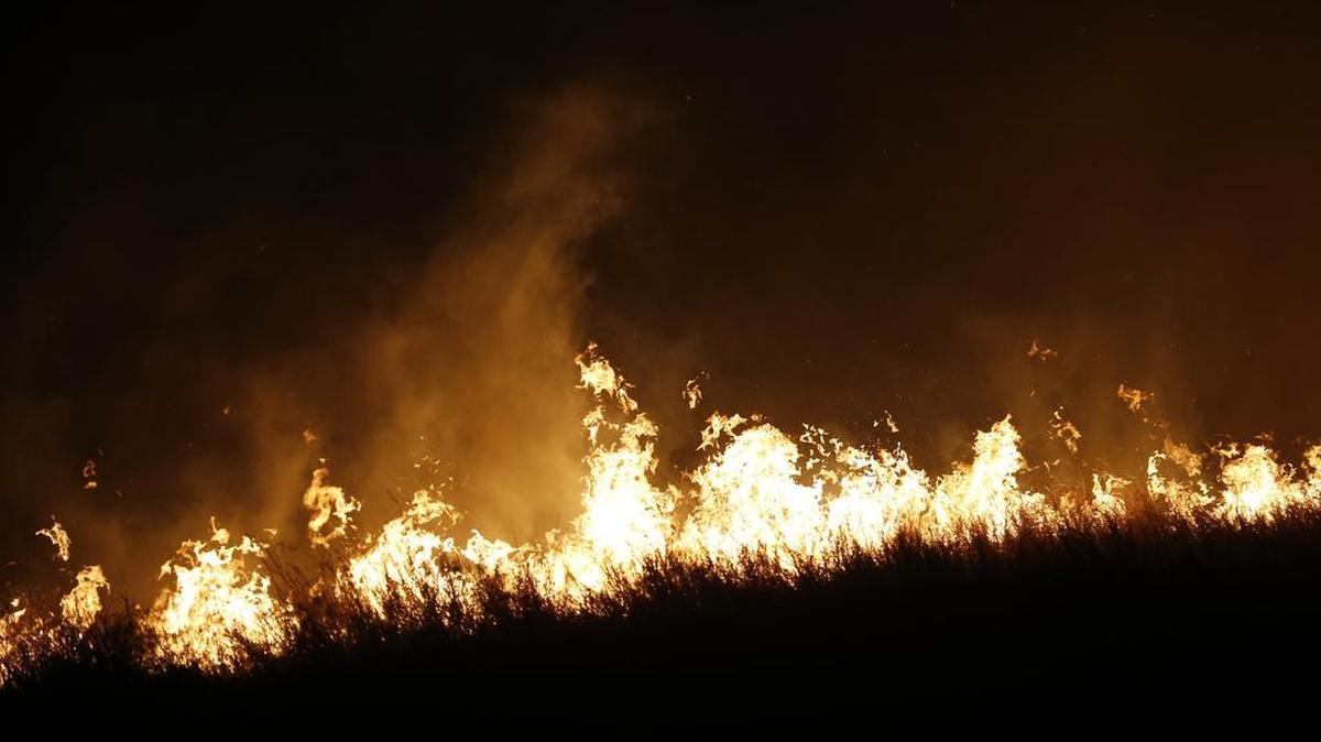 Firefighters from across Kansas and Oklahoma battle a major wildfire near Protection, Kan., on Monday night and early Tuesday morning. The fire, driven by winds gusting up to 50 mph, threatened the towns of Protection and Ashland.