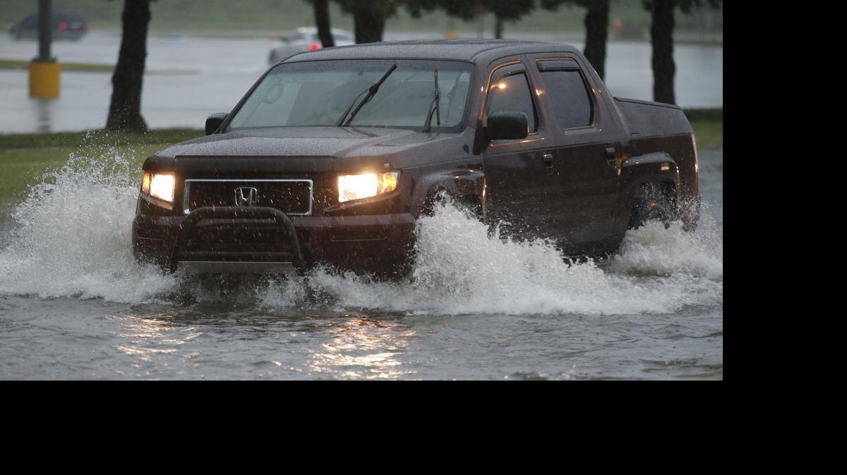 
Monday’s downpour inundated West Maple near Town West Square. Heavy rains flooded many streets in the area during the evening rush hour. (July 6, 2015)
