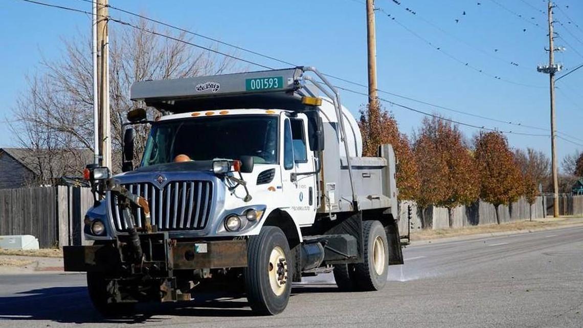 A city worker sprays a brine mixture near Pawnee and Maize Road on Dec. 5. City crews have also been out spreading the salt and water mixture this week ahead of this weekend’s predicted storm.