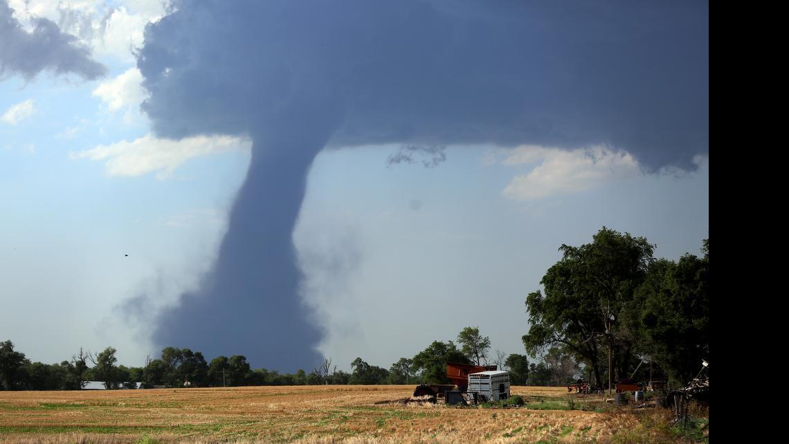 
A tornado touches down northwest of Hutchinson, Kan., Monday, July 13, 2014. (Travis Morisse/The Hutchinson News via AP) 
