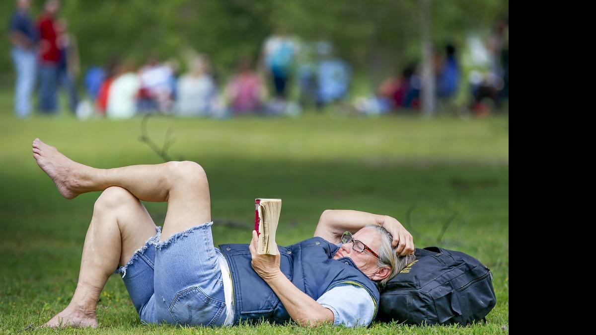 
Cathy Malone and others enjoy a warm Friday afternoon at Riverside Park. (May 1, 2015) 
