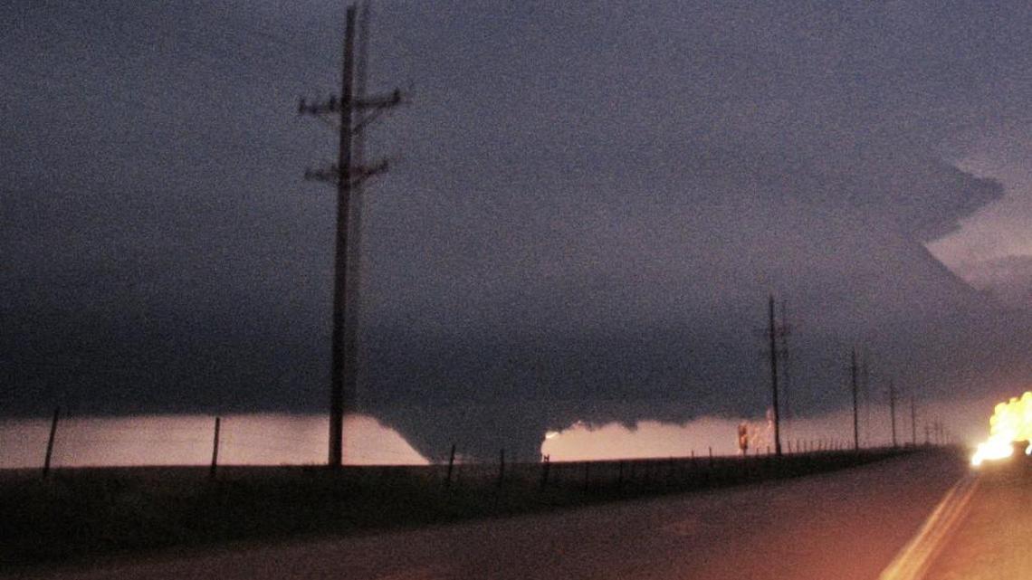 The tornado that devastated Greensburg on May 4, 2007, is illuminated by lightning as it approaches K-183 highway before it turned north and struck the city. The tornado was the first to earn the Enhanced Fujita Scale’s top rating, EF5, with winds of 205 miles an hour.