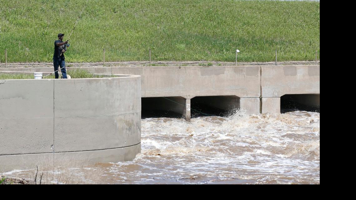 
A fisherman casts from the spillway Tuesday near I-235 and the 25th Street exit. (May 26, 2015)
