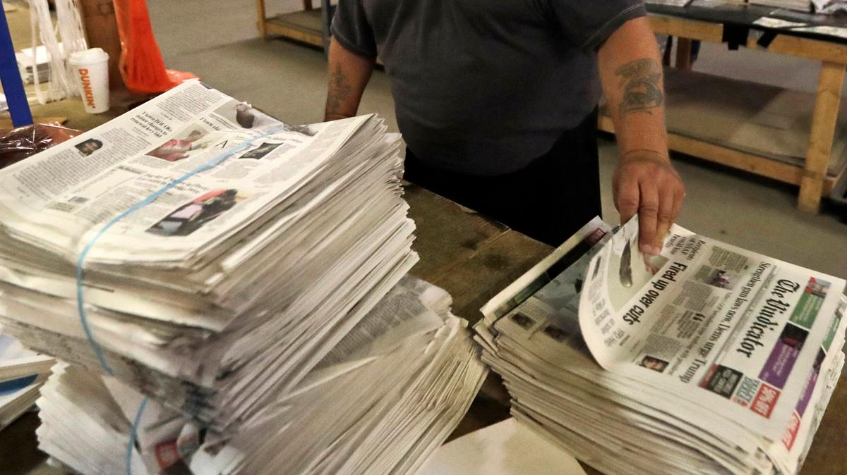 FILE - An employee sorts newspapers for delivery at a distribution center in Liberty Township near Youngstown, Ohio, on Aug. 6, 2019. Pew Research Center data released this week showed that 2020 was the first year that the newspaper industry earned more money from circulation than advertising, (AP Photo/Tony Dejak, File)