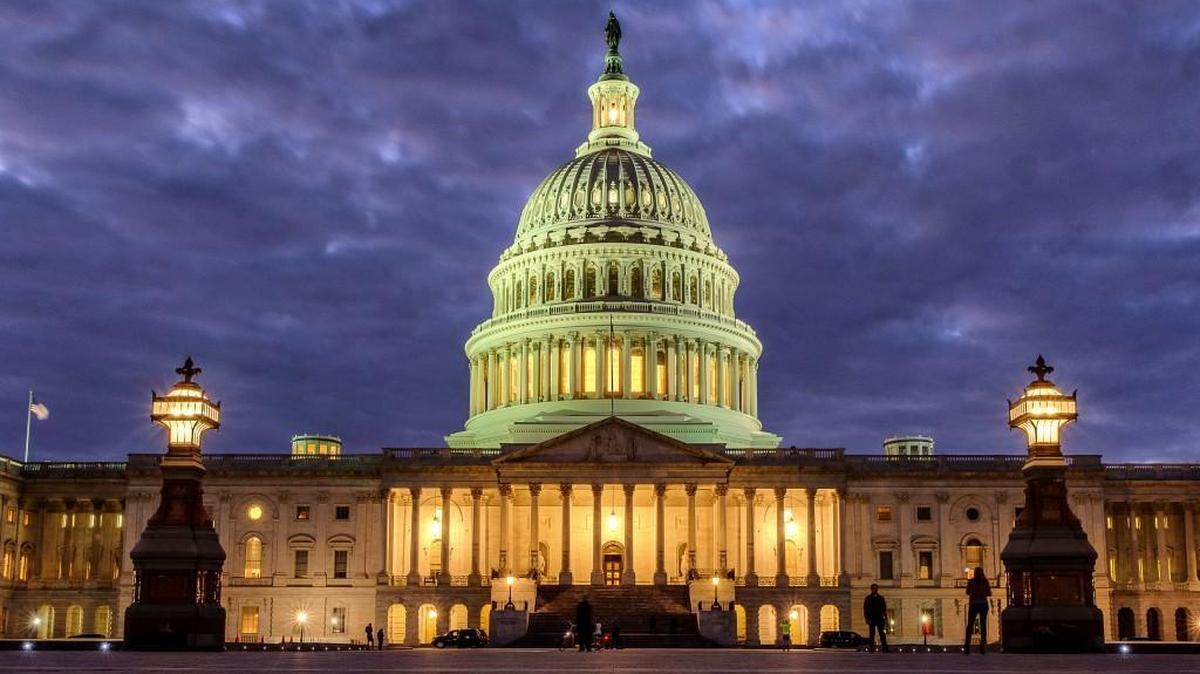 FILE - In this Jan. 21, 2018 file photo, lights shine inside the U.S. Capitol Building as night falls in Washington. Dozens of web addresses implying U.S. senators were âfor saleâ have been quietly and mysteriously purchased online, amid heightened concerns on Capitol Hill that foreign agents _ especially Russians _ might be trying to interfere in the upcoming midterm elections. The Associated Press has determined that Democrats were responsible. The cybersecurity director for the sergeant-at-arms in the Senate has begun to look into the matter. (AP Photo/J. David Ake)