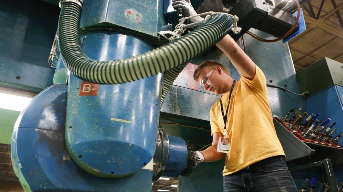 Jeffrey Parker, a 19-year-old recent Douglass High School graduate, replaces a tool on a trim and droll machine at Spirit. He was one of about 20 high school kids working at Spirit for a summer job. Spirit sees this as an opportunity to get youth interested in pursuing aircraft production jobs after graduating from high school.