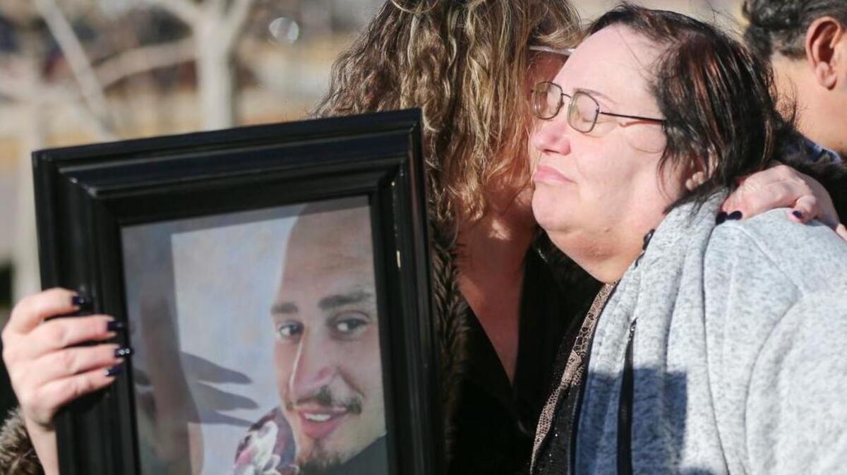 Lisa Finch, right, the mother of Andrew Finch, hugs Lorrie Hernandez, who’s holding a picture of Andrew Finch, after the family held a news conference Jan. 23.