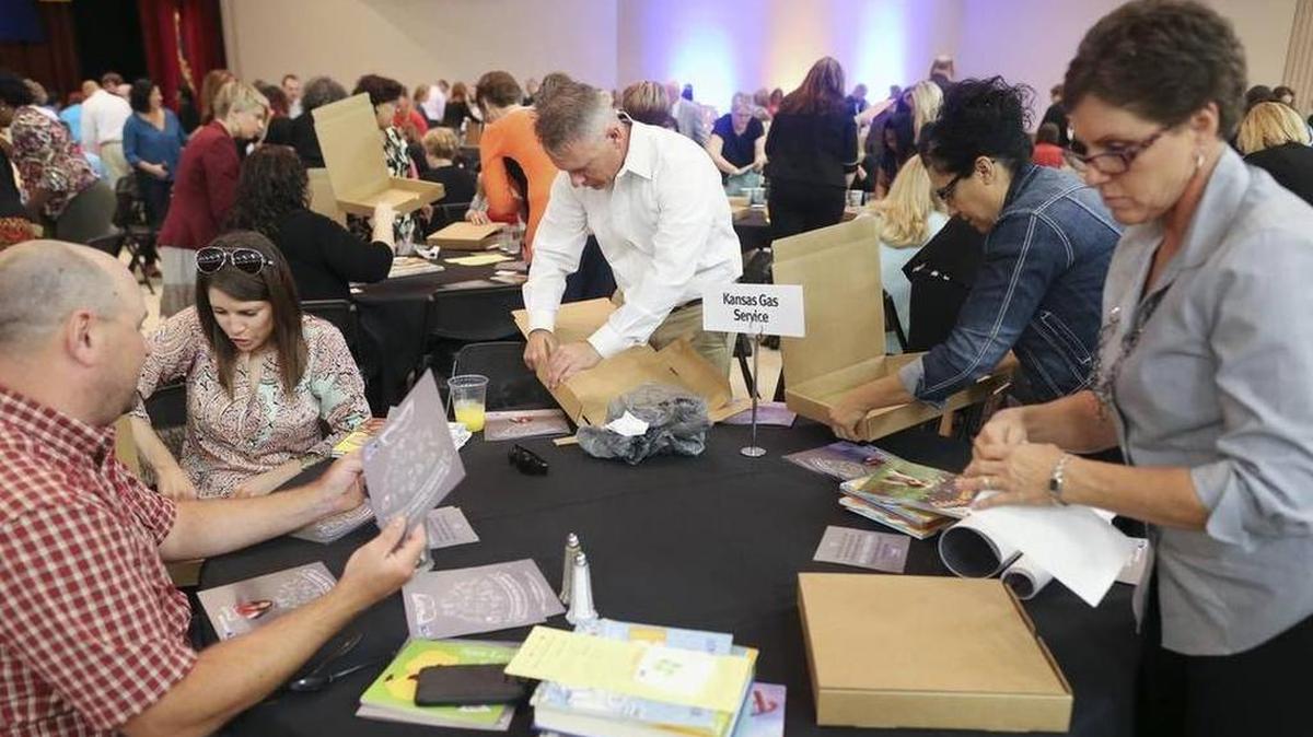 
Attendees at the United Way campaign kickoff event were put to work packing 350 reading kits of donated books.
