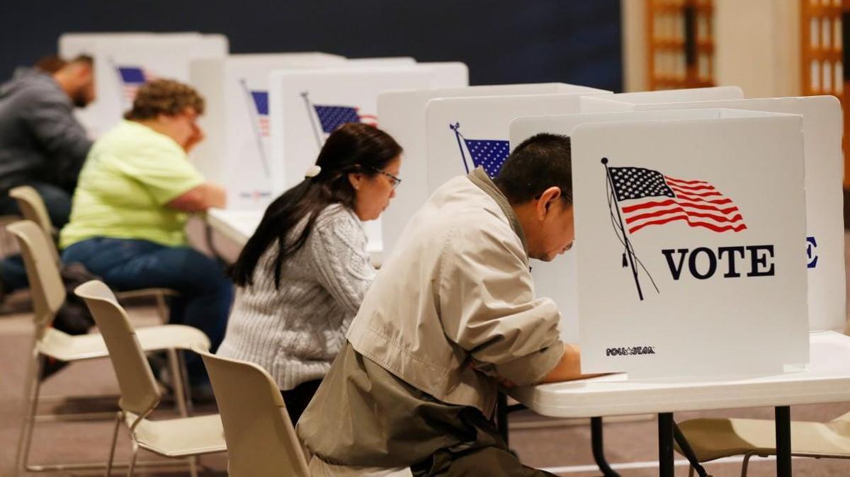 Voters fill out paper ballots at First Mennonite Brethren Church on Nov. 8, 2016.