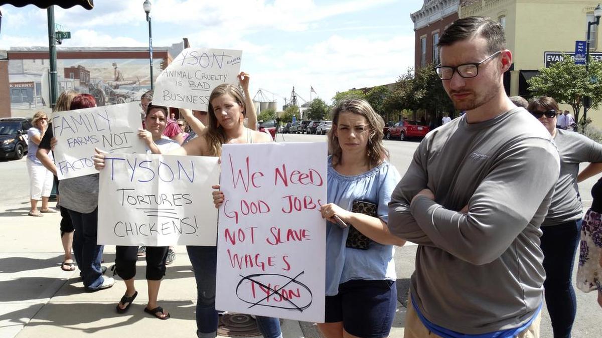 Protesters line the sidewalks in downtown Tonganoxie on Sept. 5 to protest a Tyson Foods processing plant. Tyson eventually withdrew plans to build a complex near the city. Now Sedgwick County is one of three finalists for the plant.