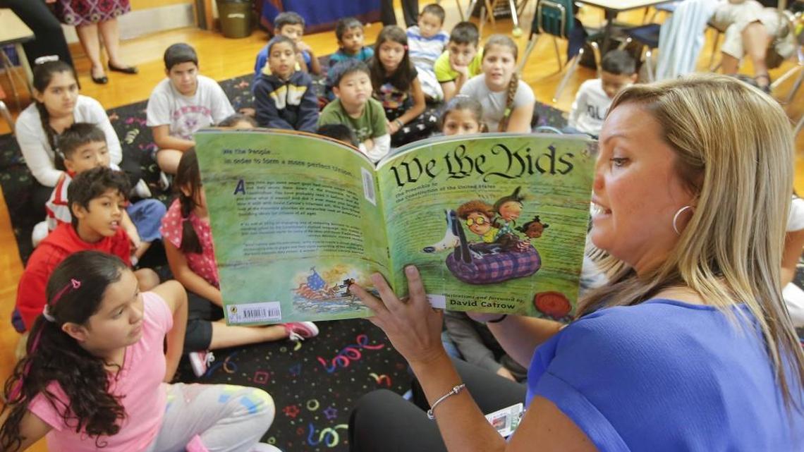 Teacher Jordan Hadley reads to the Newcomer class at Jefferson Elementary School on Tuesday. The class has 27 kids from all over the world, including Burma, Brazil, Mexico, Honduras, Vietnam, and Iran.