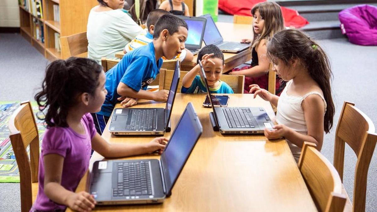 Students work with computers during Irving Elementary School's weekly summer library time in 2015.