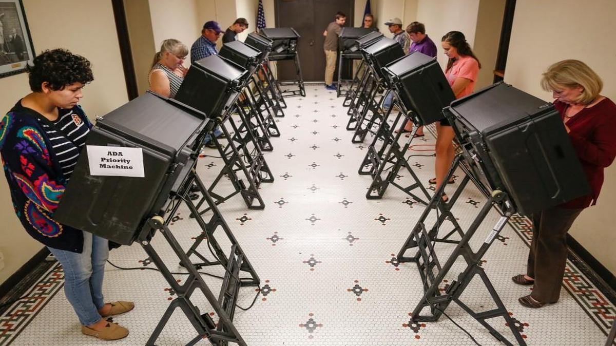People vote on electronic voting machines at the Old Sedgwick County Courthouse on Nov. 3, 2016.
