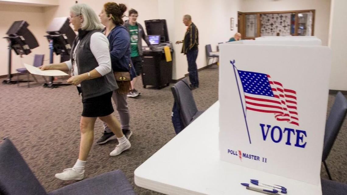 Election workers help people through the voting process as they takes advantage of early voting at Grace Presbyterian Church on Nov. 4.