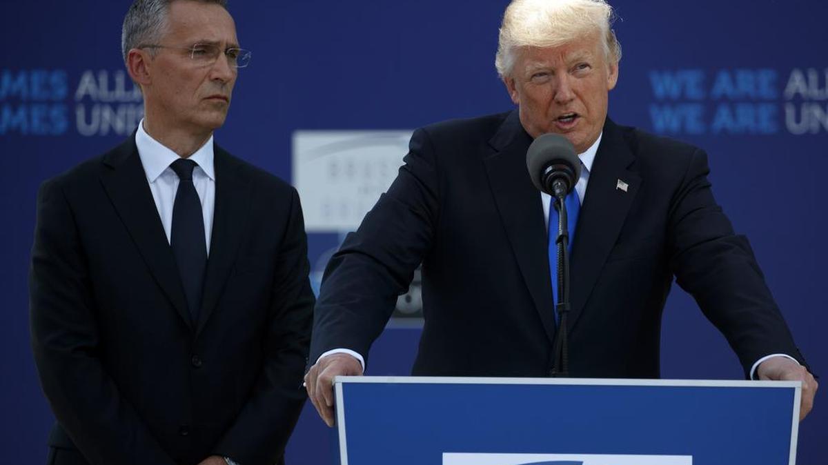 President Donald Trump, with NATO Secretary General Jens Stoltenberg, speaks during a ceremony in Brussels on May 25.