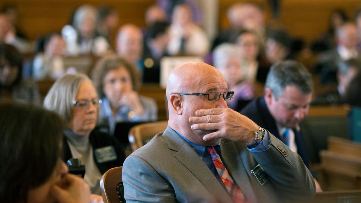 Rep. Stan Frownfelter, D-Kansas City, wipes his face after a vote to override Gov. Sam Brownback's veto of a Medicaid expansion bill failed last week.