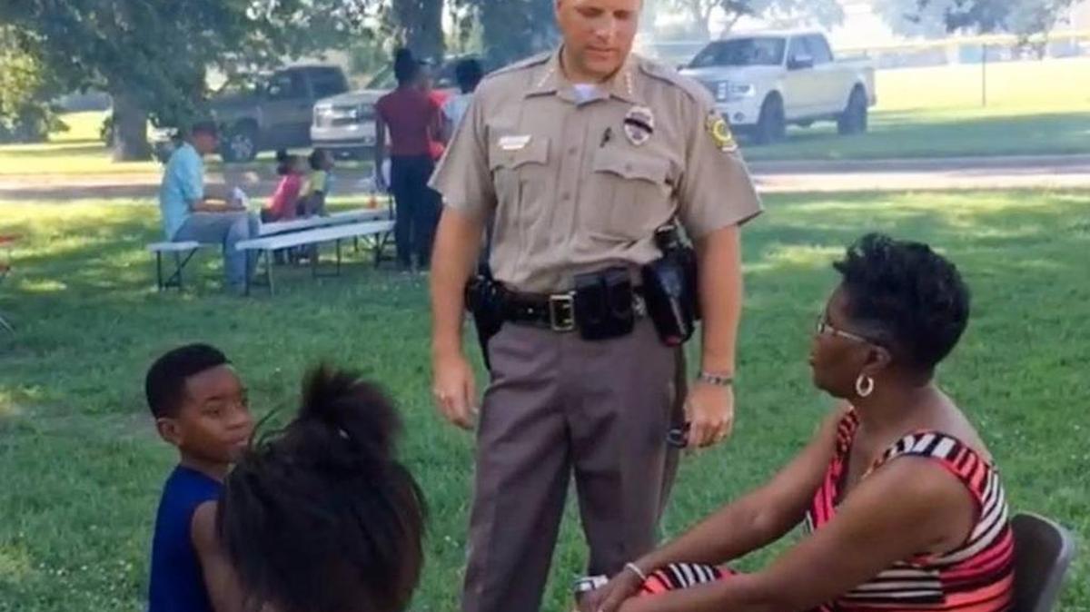 Wichita Police Chief Gordon Ramsay talks to residents at a community cookout in July.