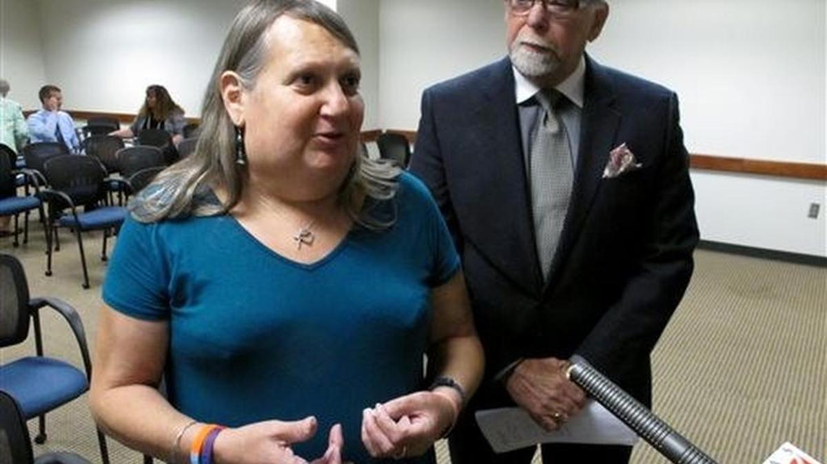 Stephanie Mott, left, a transgender Topeka woman, and Pedro Irigonegaray, her attorney, speak to reporters at the KDHE hearing.