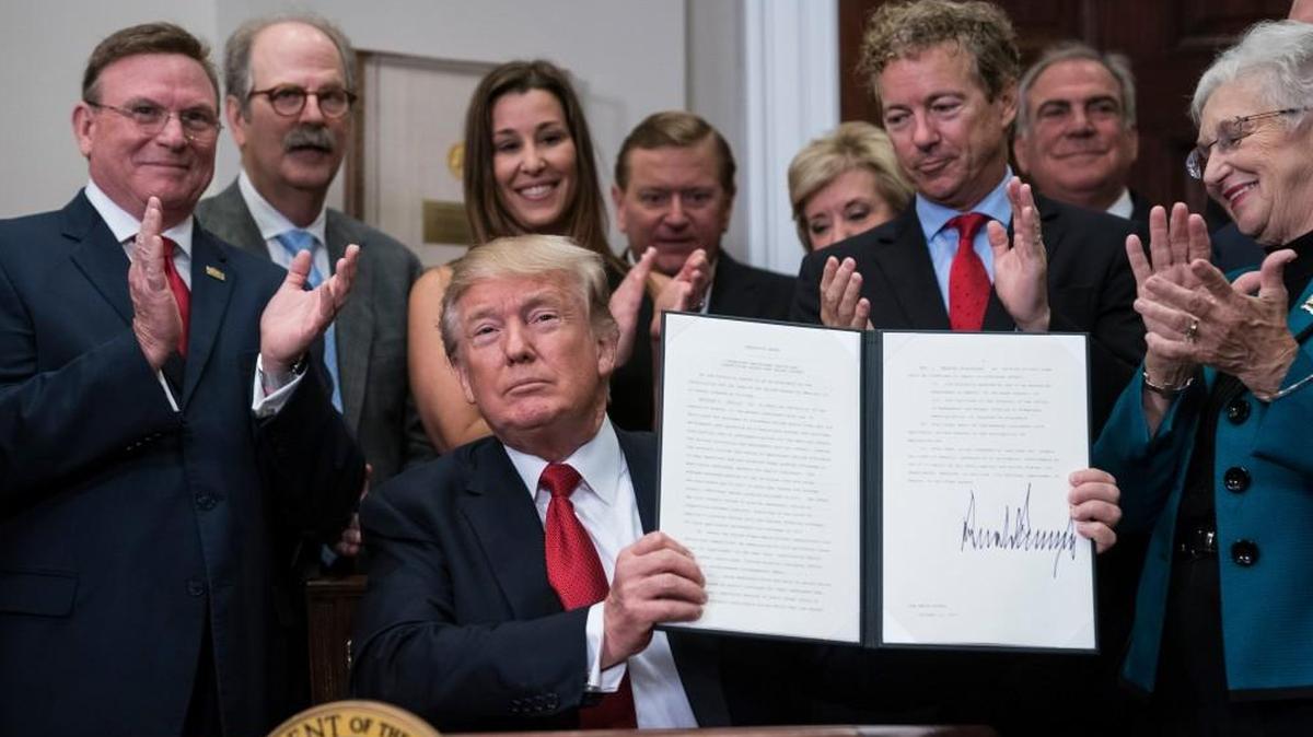 President Trump signs an executive order on health care the White House Thursday.