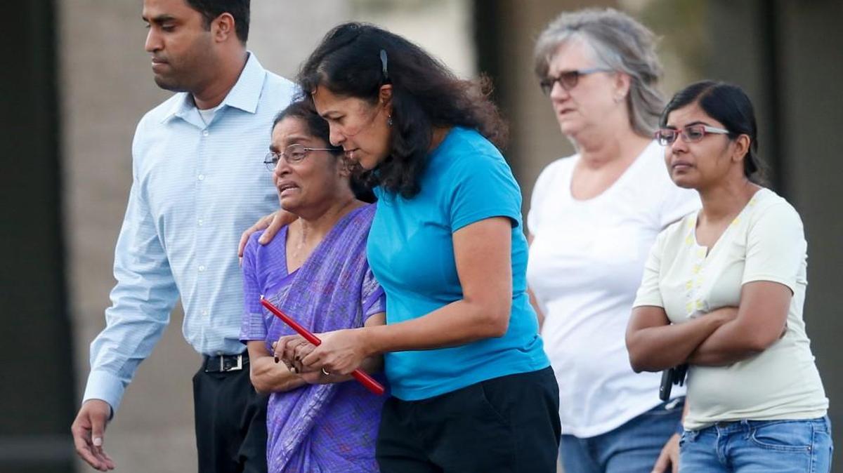 Mourners arrive before a vigil Thursday for Dr. Achutha Reddy outside his Holistic Psychiatric Services office, where he was murdered Wednesday night.