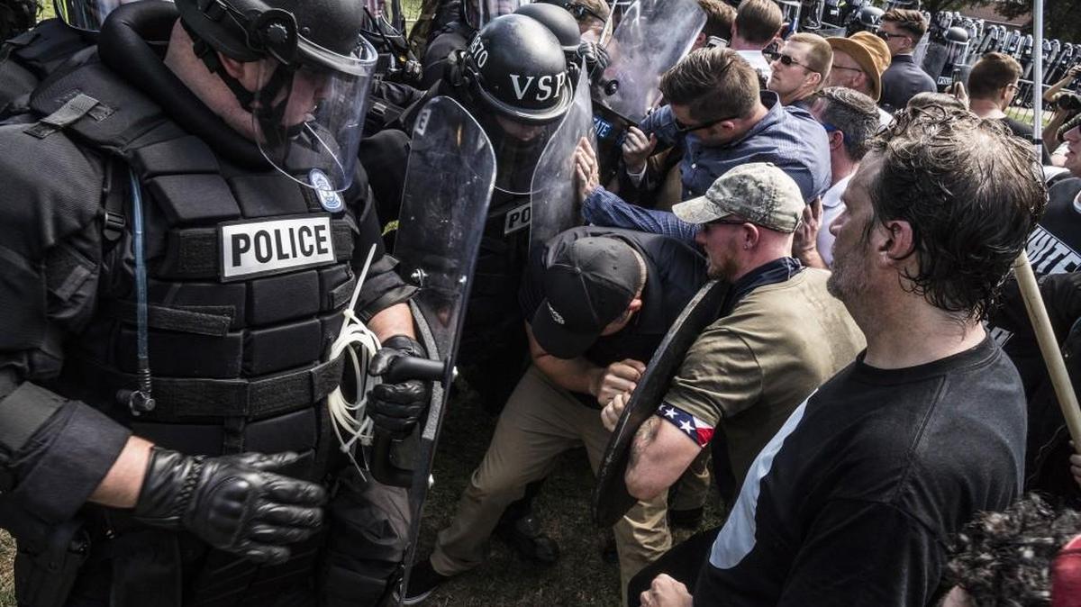 Riot police and alt-right rally members clash on Saturday in Charlottesville, Va.