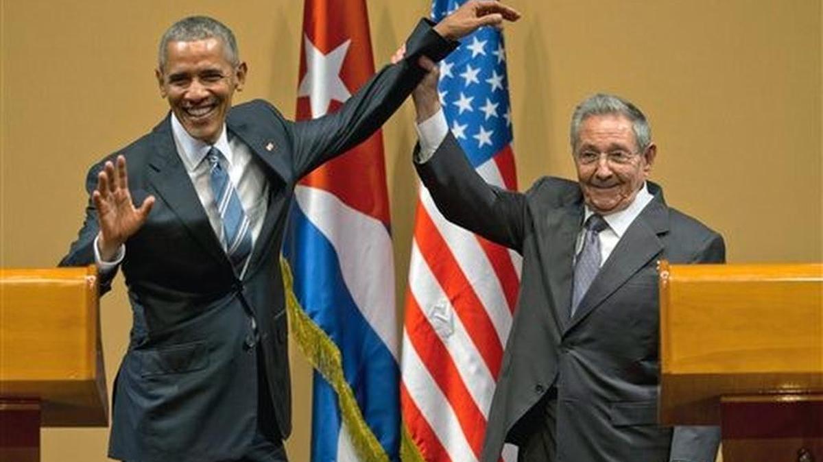 Cuban President Raul Castro lifts up the arm of President Obama at the conclusion of their joint news conference in Havana, Cuba.