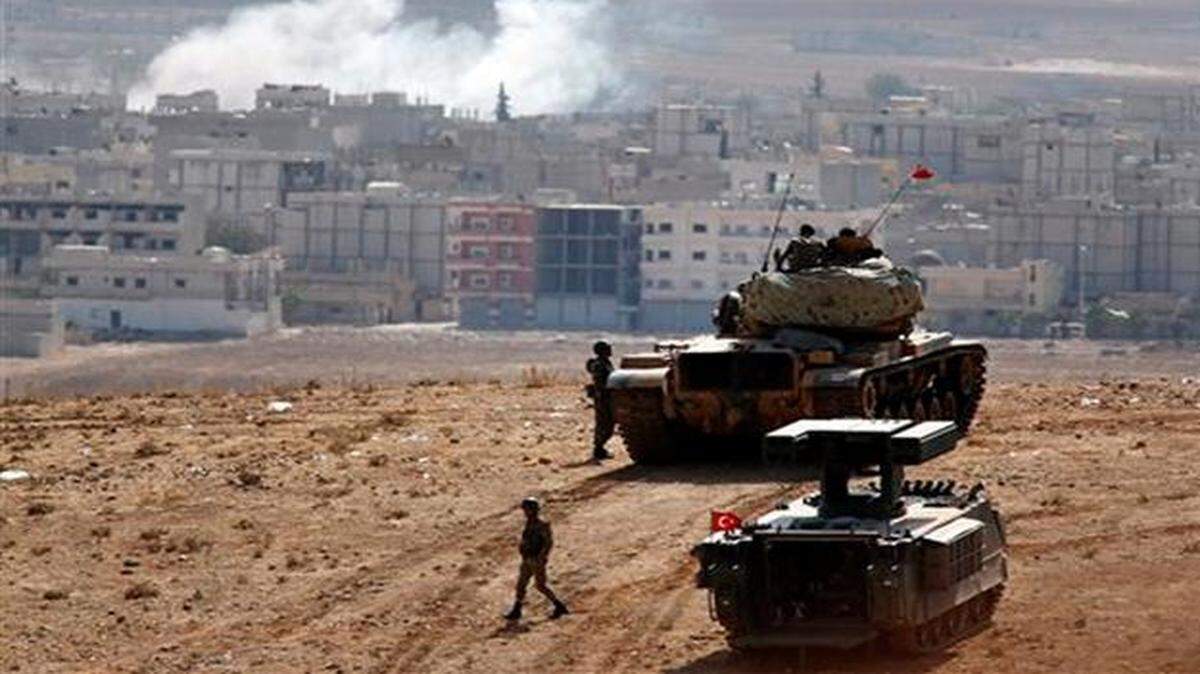 
Turkish soldiers watch fighting in Kobani, Syria, between Syrian Kurds and the militants of the Islamic State.

