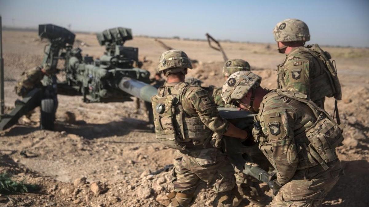 U.S. soldiers with Task Force Iron maneuver an M-777 howitzer, so it can be towed into position at Bost Airfield, Afghanistan.