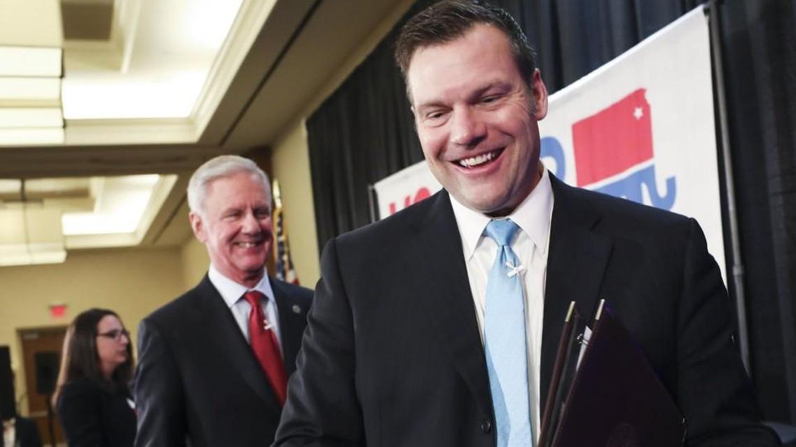 Kris Kobach, right, and Wink Hartman.