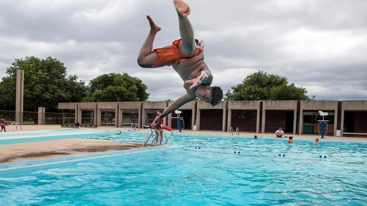 Josh McElroy does a flip off the McAdams pool’s diving board in 2015. The Wichita parks department closed the pool before this swim season.