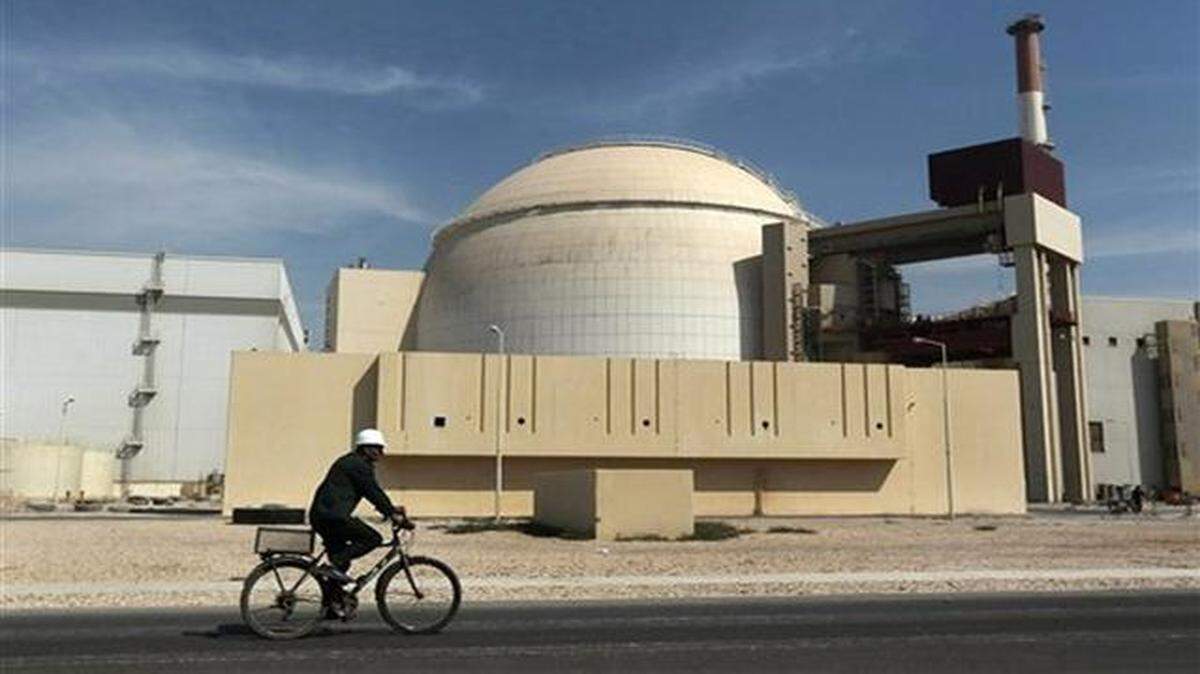 
A worker rides a bicycle in front of the reactor building of the Bushehr nuclear power plant in Iran.

