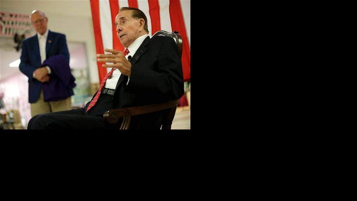 
Republican Sen. Pat Roberts listens while former Senate Majority Leader Bob Dole, right, speaks during a campaign stop at a mall in Dodge City on Monday.
