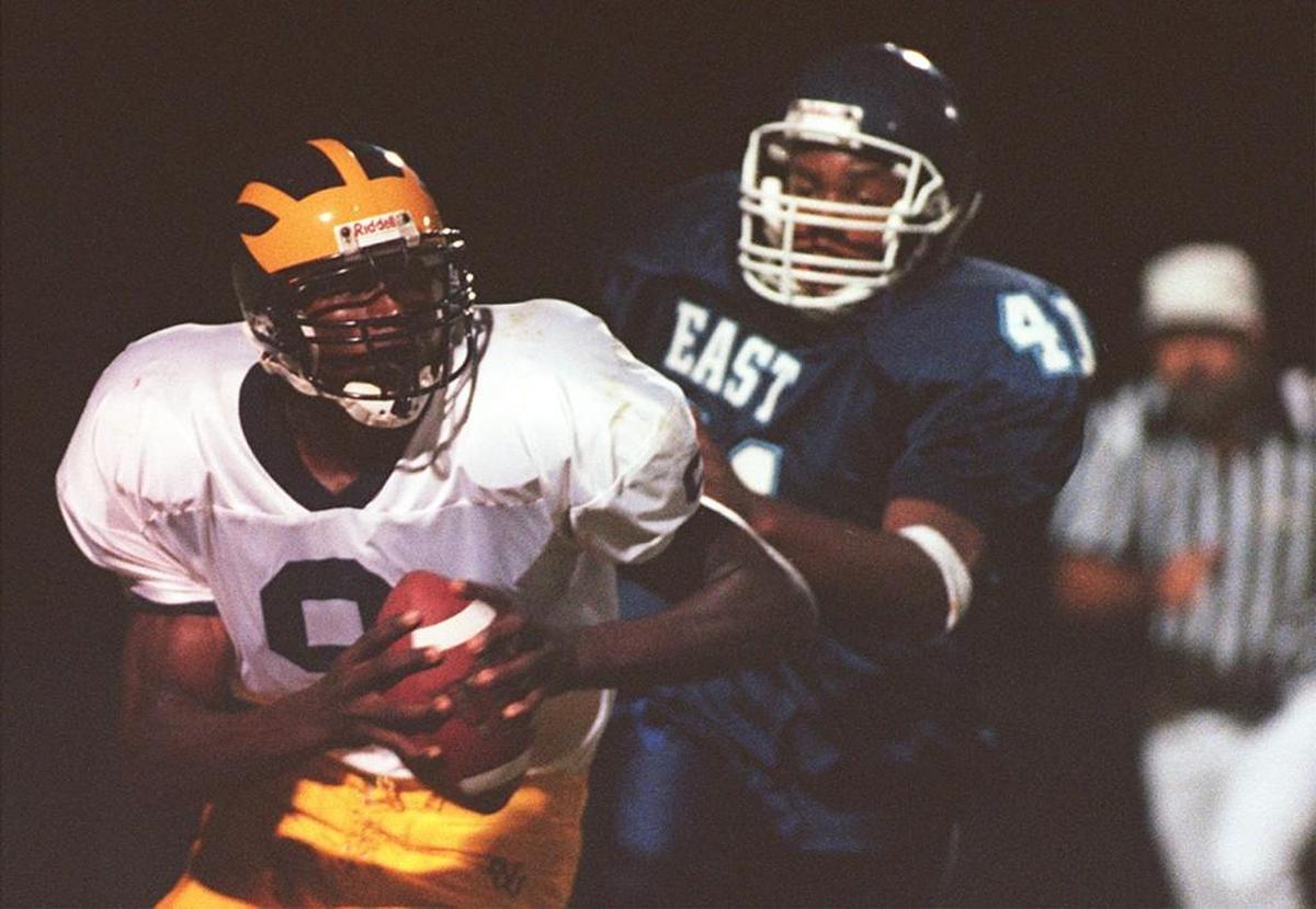 Kamerion Wimbley, left, was a two-year starter at quarterback for Northwest High in the early 2000s before finding fame at Florida State and in the NFL as a defensive player.