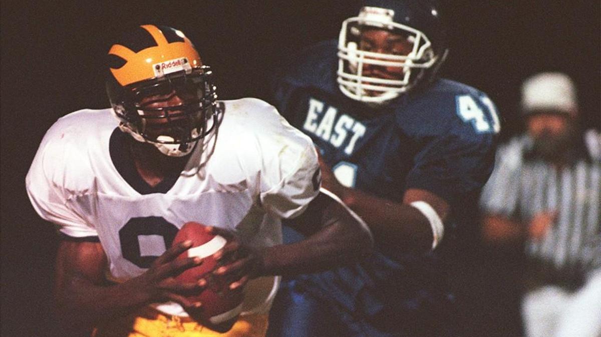 Kamerion Wimbley, left, was a two-year starter at quarterback for Northwest High in the early 2000s before finding fame at Florida State and in the NFL as a defensive player.