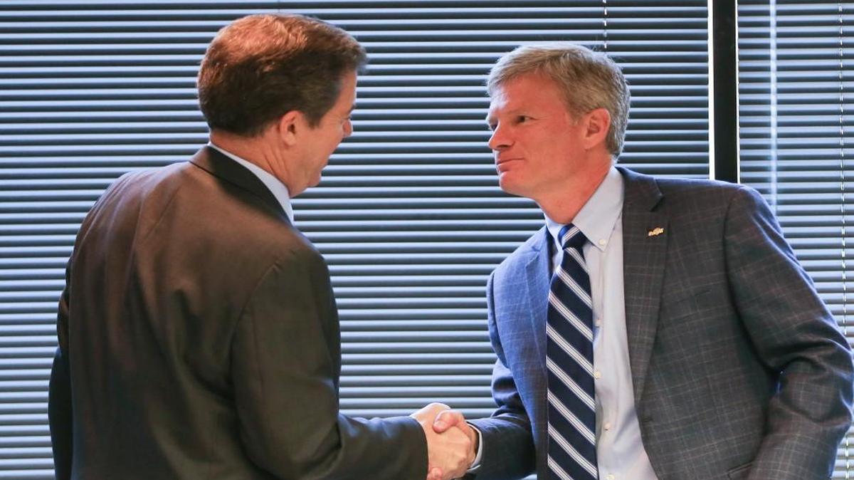Cargill Protein president Brian Sikes, right, shakes hands with Gov. Sam Brownback after it was announced in May 2016 that Cargill would keep its protein division in Wichita.
