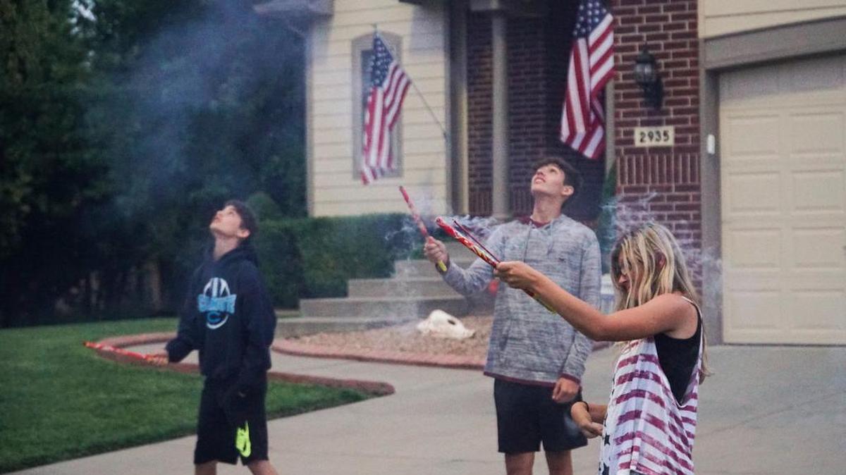 Teens light Roman candles during a July 4 party in Wichita. The fireworks are illegal in the city.